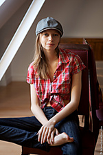 A stylish sweetie plays with her pussy