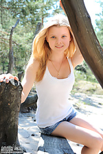 Teen posing between trees Teen posing between trees