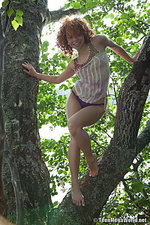 Red-haired nymph masturbating outdoors