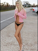 Jana stands on the side of the road with just tape over her nipples