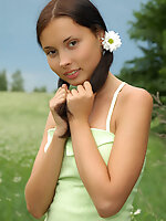 Marvelous nude babe with two pretty ponytails has a walk in the field of chamomiles and fondles her tender skin with them.
