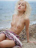 An amazing strip and tease show by a gorgeous skinny teen babe who shows her flawless slim body outdoors at a beach.