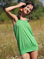 Marvelous teen girl in striped socks undressing and showing slender body on the nature. Amour Angels