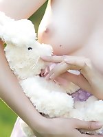 Adorable teen kitty with perfect milk white skin shows off her petite nude body on a lawn.