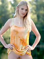 Shy and innocent blond takes her dress off in the forest.