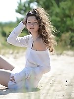 The beach and sunshine only adds to her stunning teen beauty and the way she slowly strips naked from her clothes.