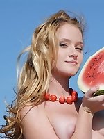 Adorable cutie enjoys her picnic with watermelon and shows off her perfect tits and pussy.