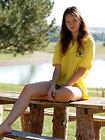 Passionate teen girl with long legs poses on the nature, showing her body from different points of view.