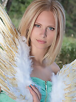 Amazing blonde teen babe gets naked on the lap of nature and tries to mimic some angelic beauty with her poses.