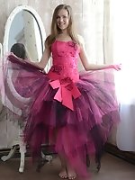 Gorgeous teen cutie stripping an evening dress and showing body in front of a big mirror.