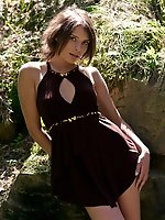 Appealing brunette strips her short dress in the woods to show off in all her nude glory.