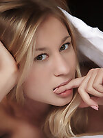 Naughty and playful felicity poses teasing on top of the bed, spreading her legs wide open to showcase her pink pussy and cute, trimmed bush.