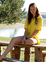 Passionate teen girl with long legs poses on the nature, showing her body from different points of view.
