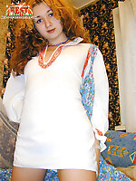 Russian hottie with a tight body stripping her ethnic dress and spreading her pussy