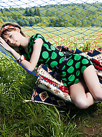 Cute teen girl lounges in a hammock and shows us she wears nothing underneath her dress.