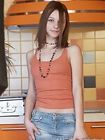 Lovely teen showing outstanding striptease in the kitchen