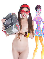 Gorgeous dark haired teen girl with red glasses in the shape of hearts posing with tape recorder.