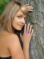 Charming girl seductively stripping her summer dress and getting totally nude in the woods.