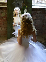 Stunning blonde teen celebrates her early marriage with stripping her bride clothes and shows some of her naked body.