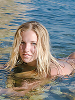 Adorable busty blonde teen cutie with great boobs posing absolutely naked naked in sea.