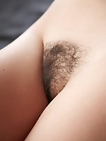Jasna showcases her delectable and fresh unshaven labia and beautiful perky breasts with a warm, engaging smile on the bed.