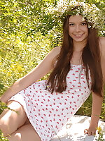 Adorable teen with a wreath in excellent long hair undressing and showing body in the woods.