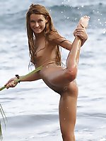 Fun and carefree, masha frolics on beach, with sand and frothy water on her tight, untrimmed body.