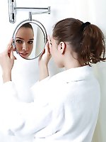 Natural teen takes off her gown before the bath
