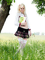 Pretty white skinned blonde teen in white stockings and plaid skirt getting naked outside.