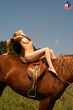 Sexy chick poses on a sorrel horse