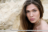 Natural and unadorned beauty of chiara amidst a desolate, rugged landscape.