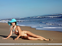 Smoldering blonde enjoying the sun and the sea by herself.